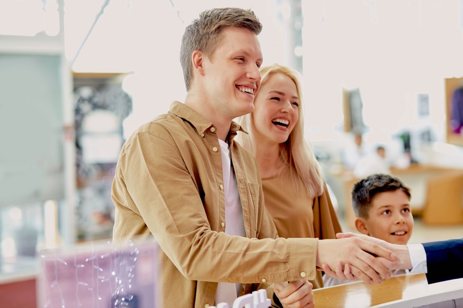 smiling family shaking hands